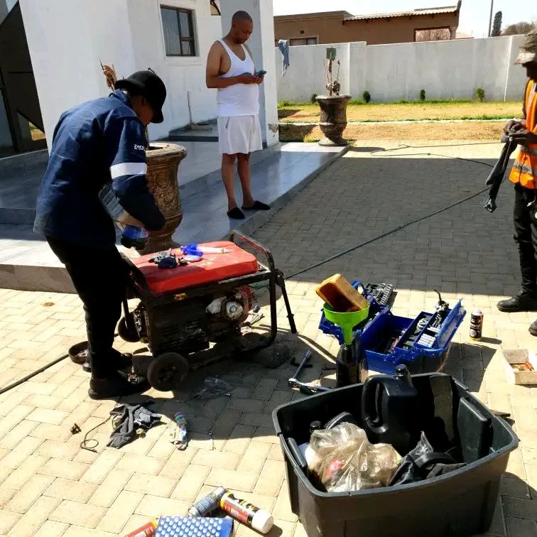 Technician servicing a portable petrol generator